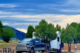 A truck pulling a fifth wheel camper into an rv site at Soda Creek Campground in Soda Springs, Idaho.