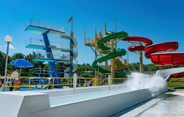 A teenager sliding down one of the red, blue, and green waterslides at Lava Hot Springs near Soda Creek Campground in Soda Springs, Idaho.